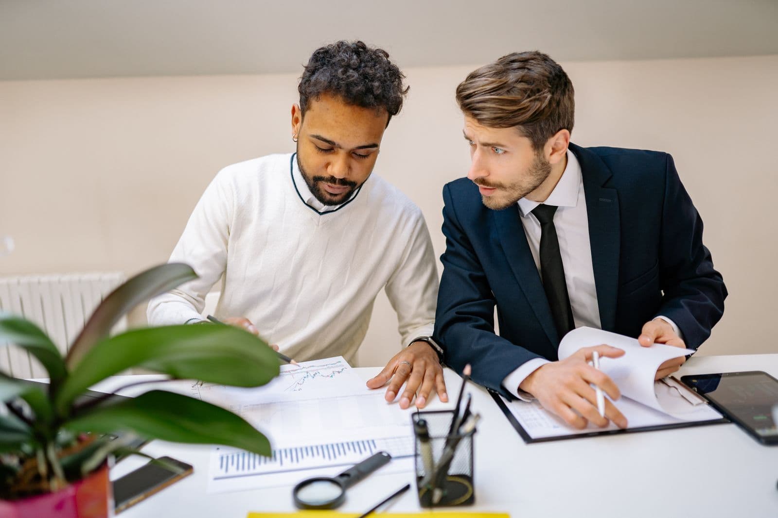 Two professionals analyzing link building reports