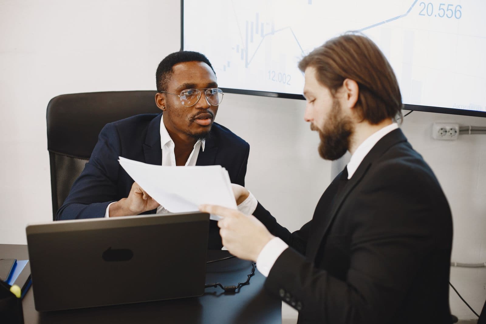 Two professionals discussing web hosting in a meeting
